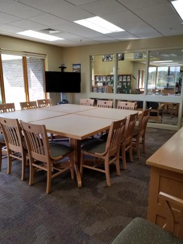 21st Century Conference Room show a large square table with multiple chairs and a mounted tv