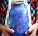 hands holding nebula jar