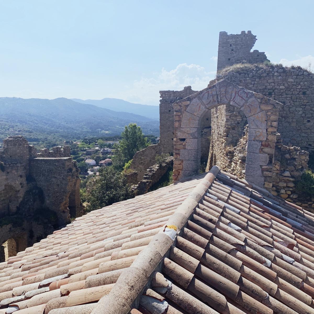 Northern Spanish castle ruins, overlooking a small Spanish city with mountains in the background